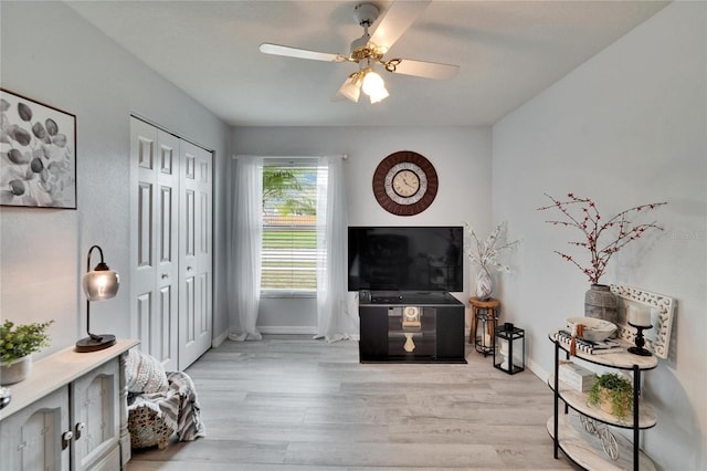 interior space with light wood-type flooring, baseboards, and a ceiling fan