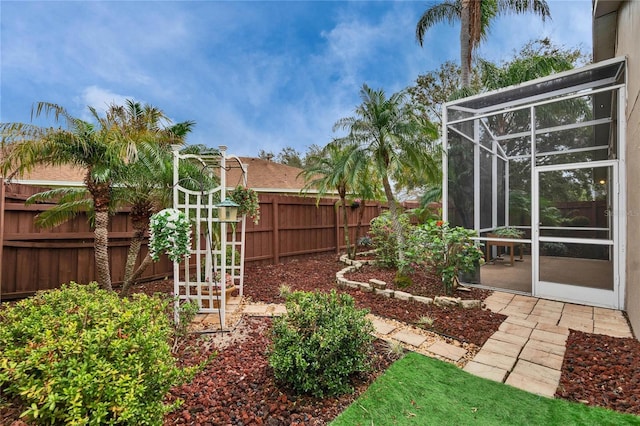 view of yard with fence private yard and glass enclosure