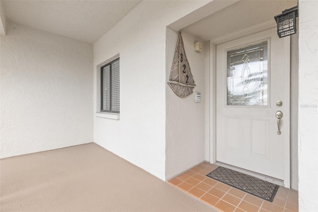 entrance to property featuring stucco siding