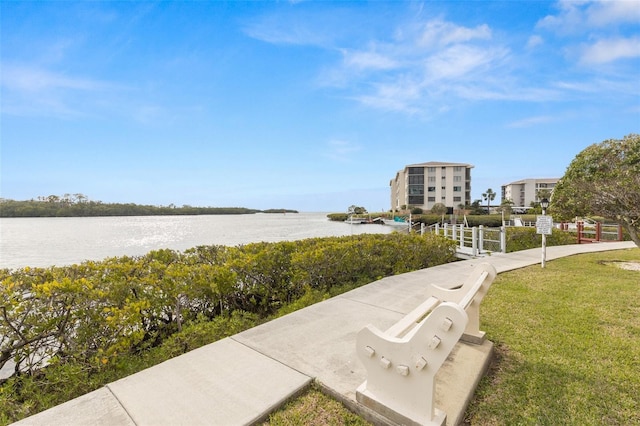 view of home's community featuring a water view and a yard