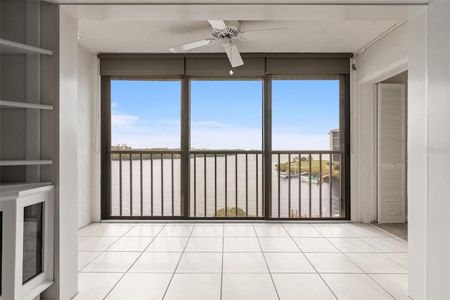 unfurnished sunroom featuring ceiling fan
