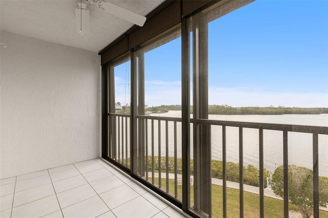 interior space featuring a water view and ceiling fan
