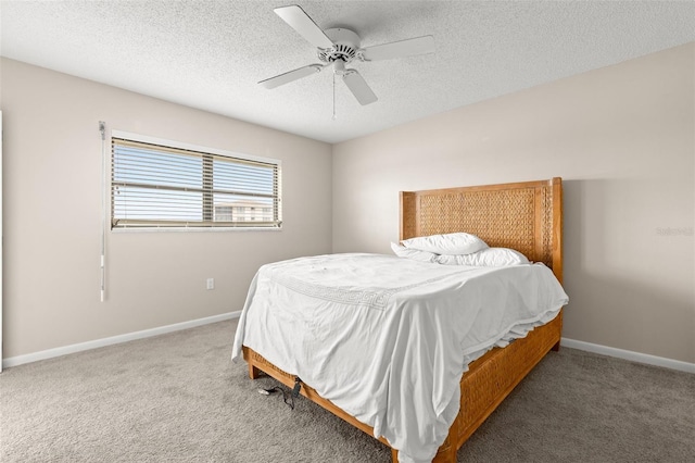 carpeted bedroom with a textured ceiling, a ceiling fan, and baseboards
