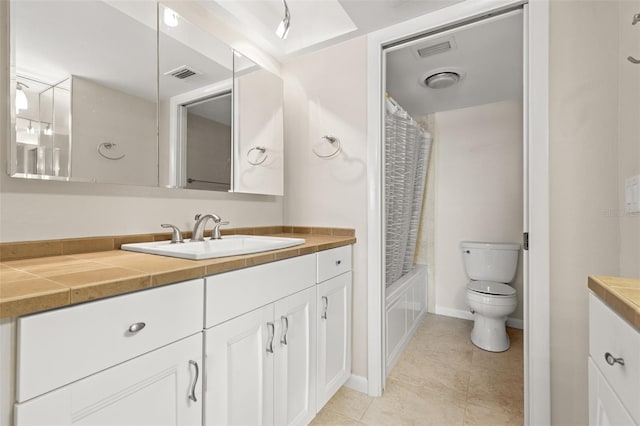 bathroom featuring visible vents, toilet, tile patterned floors, shower / bath combination with curtain, and vanity