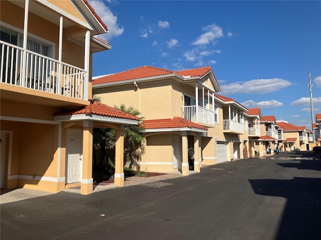 view of property with a garage and a residential view