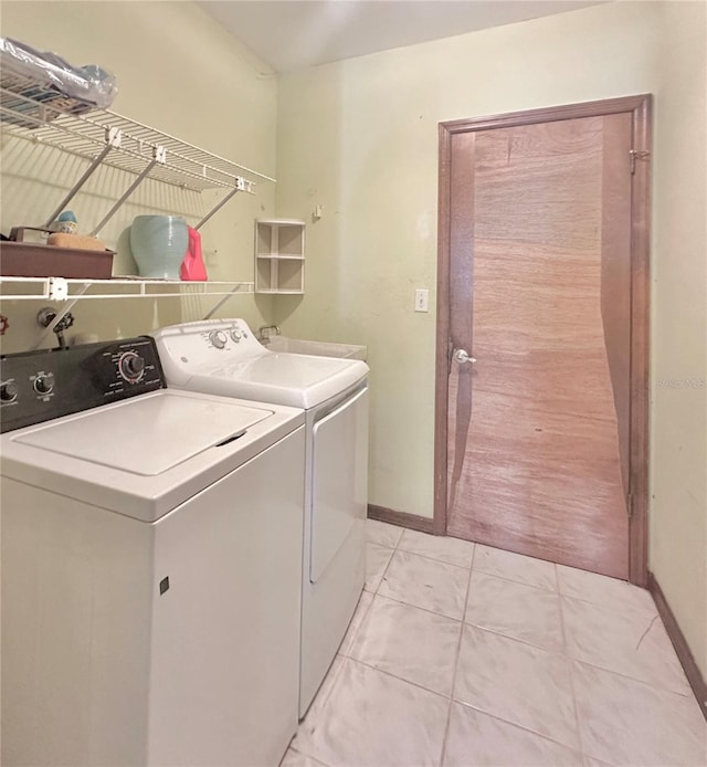 laundry room featuring laundry area, baseboards, and separate washer and dryer