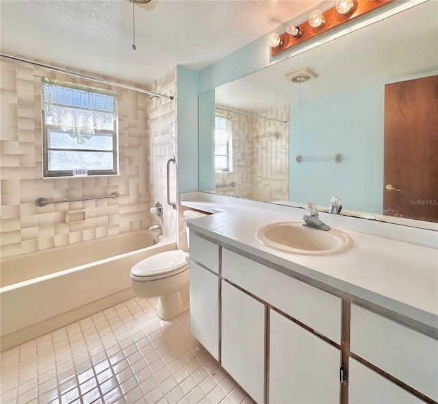 full bath featuring toilet, tile patterned floors, bathtub / shower combination, a textured ceiling, and vanity