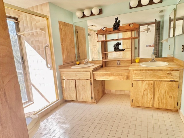 bathroom with double vanity, a sink, visible vents, and a shower stall