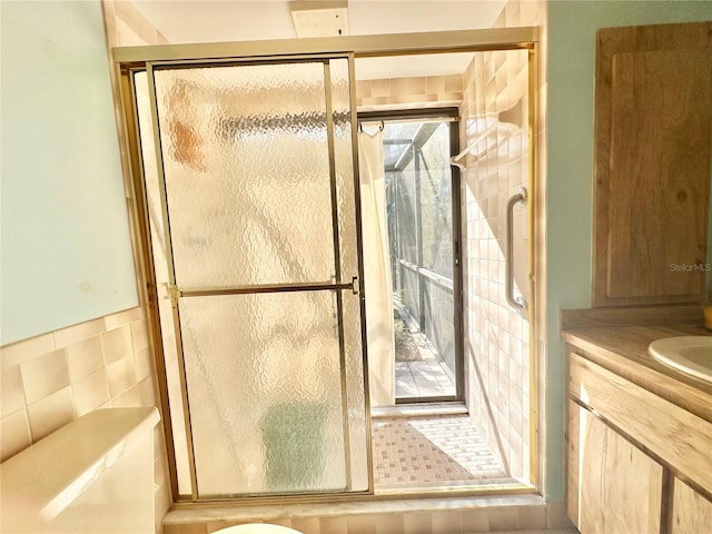 full bathroom featuring a stall shower, plenty of natural light, and vanity