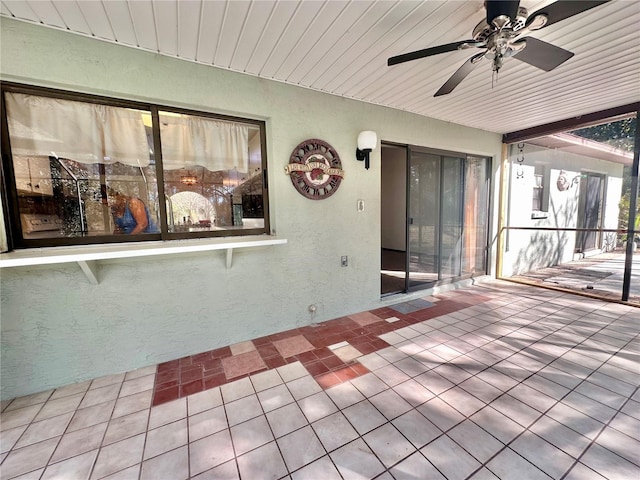 unfurnished sunroom featuring wooden ceiling and ceiling fan