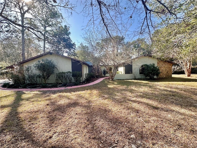 view of property exterior with a yard and stucco siding