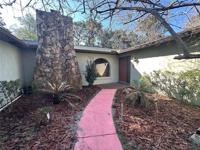 view of exterior entry featuring stucco siding