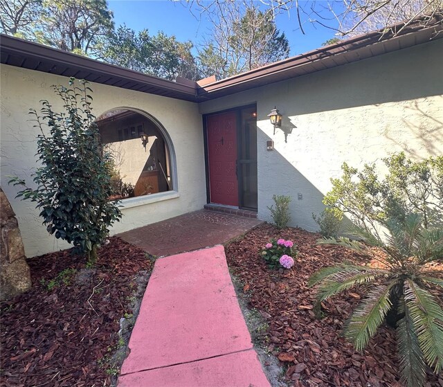 doorway to property with stucco siding