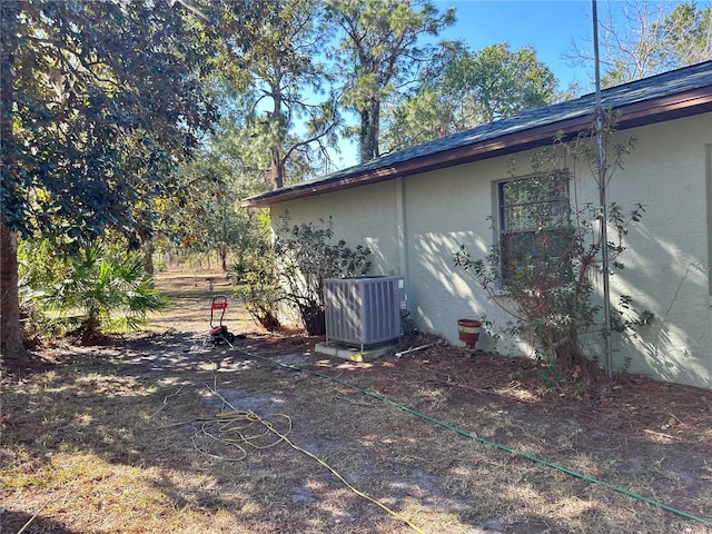 view of property exterior featuring central AC unit and stucco siding