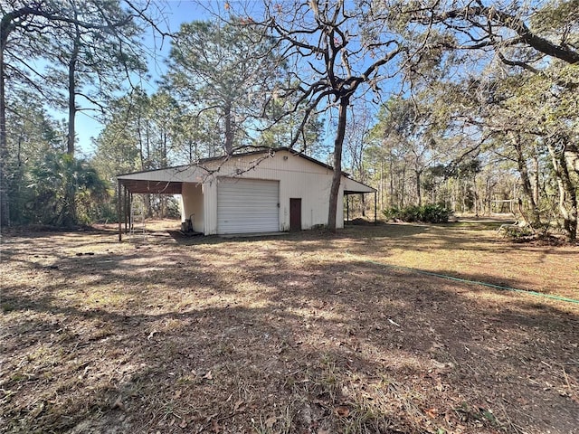 garage featuring driveway and a detached garage