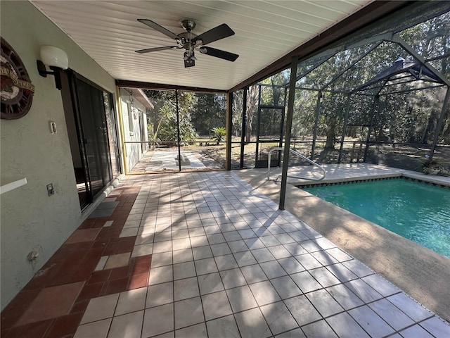 exterior space with glass enclosure, ceiling fan, and an outdoor pool