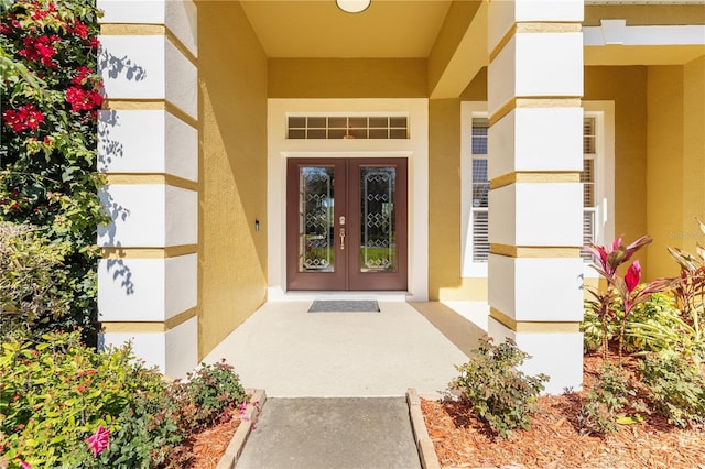 doorway to property featuring french doors and stucco siding