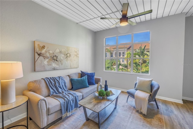 living area featuring a ceiling fan, wood ceiling, baseboards, and wood finished floors