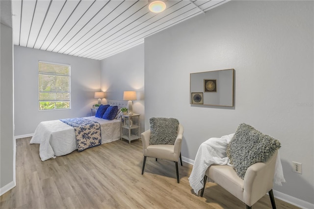 bedroom featuring wood ceiling, baseboards, and wood finished floors