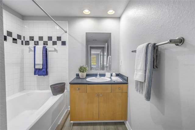 2402 W Azeele St Unit 423, Tampa, FL 33609 - full bath with vanity, wood finished floors, bathing tub / shower combination, and a textured wall