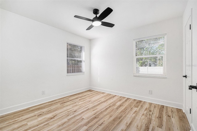 unfurnished room featuring ceiling fan, baseboards, and wood finished floors