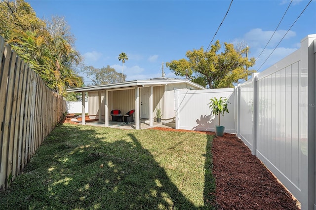 back of property featuring a fenced backyard, a yard, and a patio