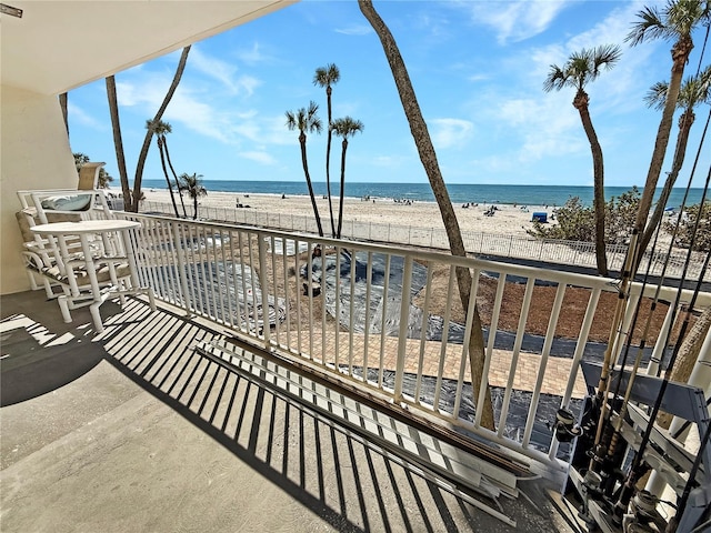 balcony with a beach view and a water view