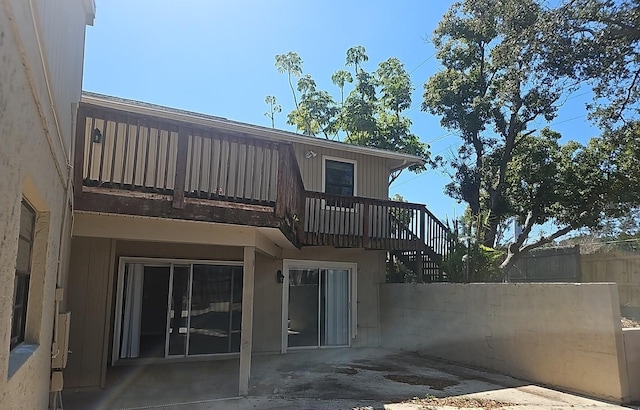 rear view of house featuring a patio area and fence