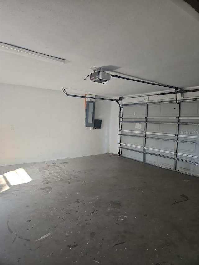 garage featuring electric panel and a garage door opener