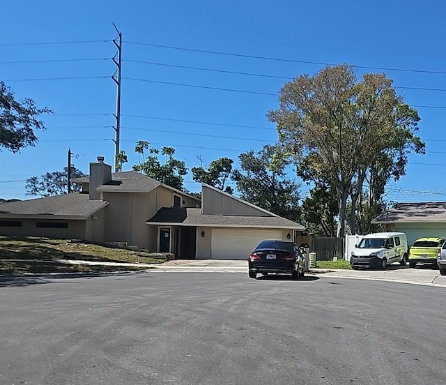 exterior space with a garage, fence, and driveway