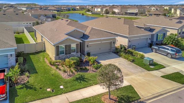 drone / aerial view with a residential view and a water view