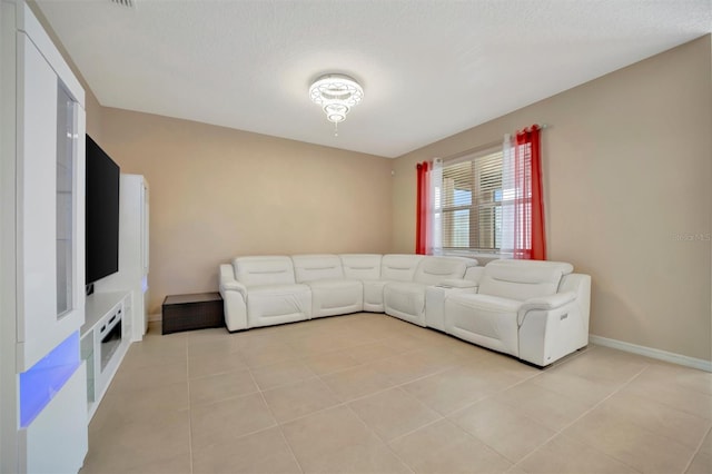 unfurnished living room featuring baseboards and light tile patterned flooring