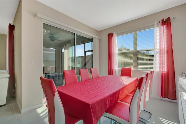 dining space with light tile patterned floors and ceiling fan