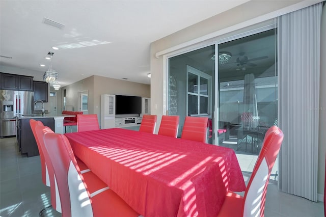 dining space featuring light tile patterned floors, visible vents, and ceiling fan