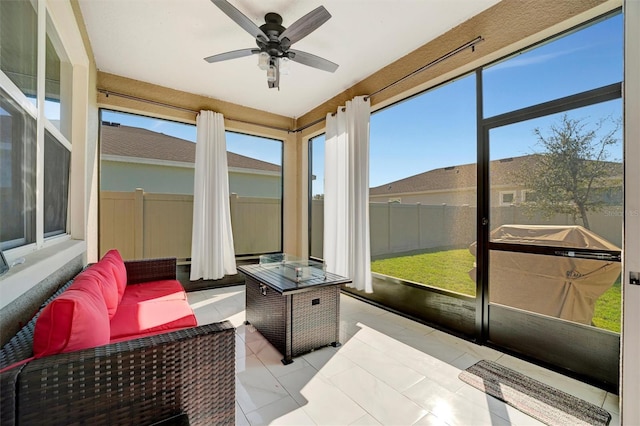 sunroom featuring a ceiling fan