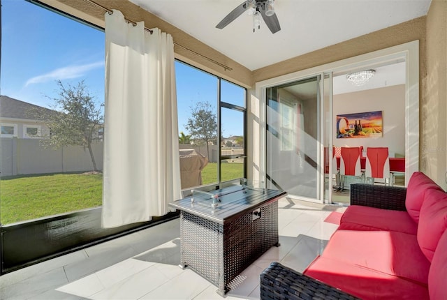 sunroom featuring a ceiling fan