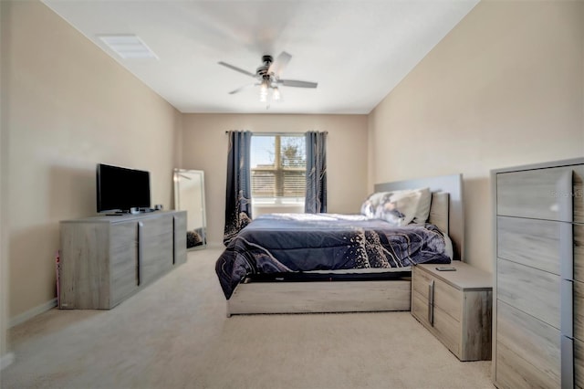 bedroom featuring light carpet and a ceiling fan