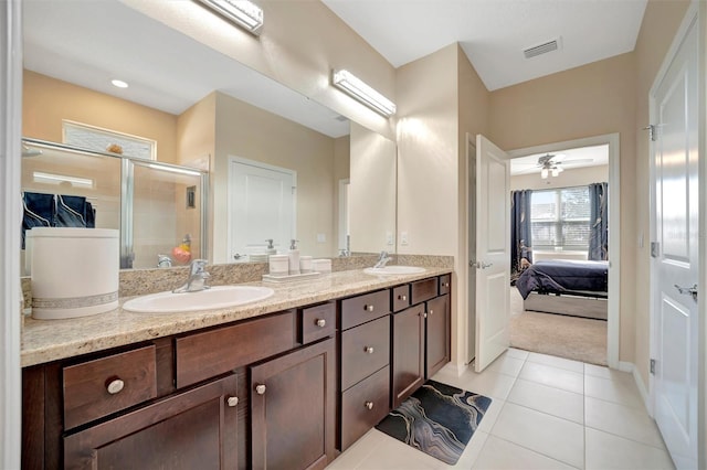 ensuite bathroom with tile patterned flooring, ensuite bath, a stall shower, and a sink