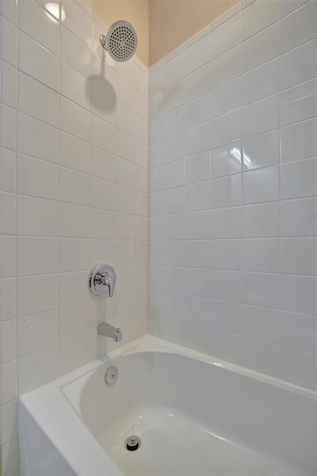 bathroom with bathing tub / shower combination