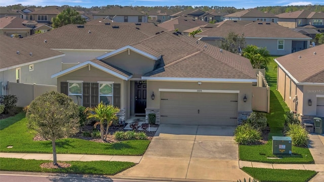 ranch-style home with an attached garage, fence, a residential view, stucco siding, and driveway