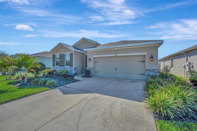 single story home with a garage, stone siding, driveway, and stucco siding