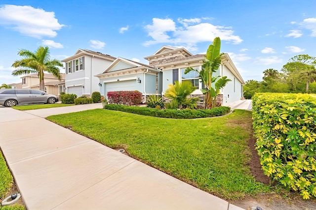 view of front of property featuring a garage, stucco siding, driveway, and a front yard