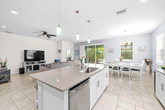 kitchen featuring light tile patterned floors, a healthy amount of sunlight, dishwasher, and a sink