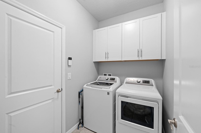 laundry room featuring cabinet space, washing machine and dryer, and baseboards