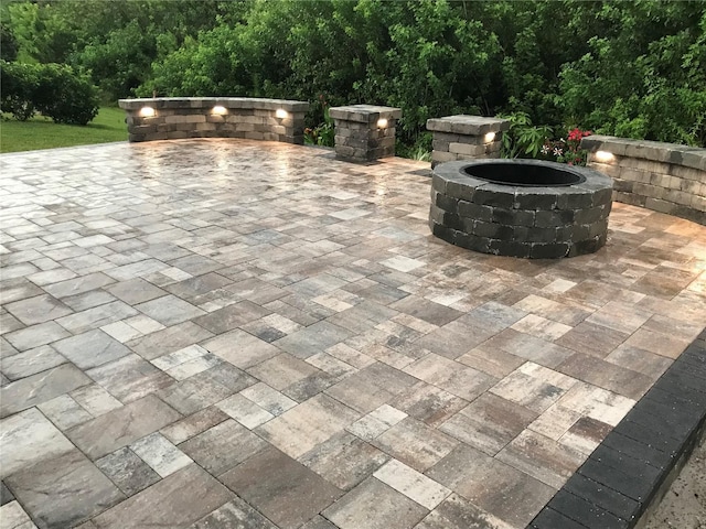 view of patio / terrace featuring an outdoor fire pit