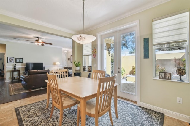 dining room with ceiling fan, french doors, ornamental molding, and baseboards