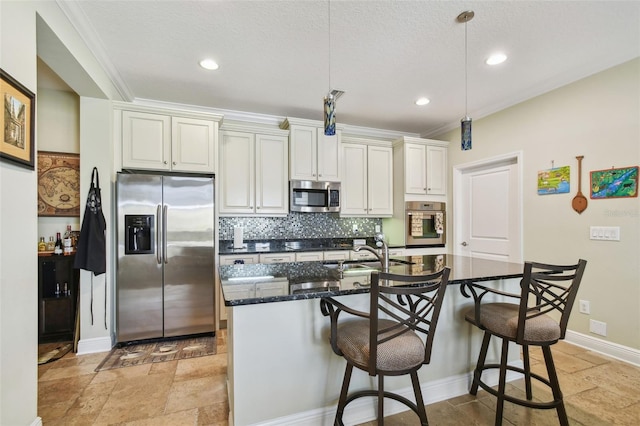 kitchen with stainless steel appliances, tasteful backsplash, a kitchen bar, and stone tile flooring