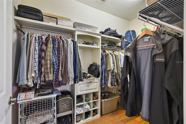 walk in closet featuring wood finished floors