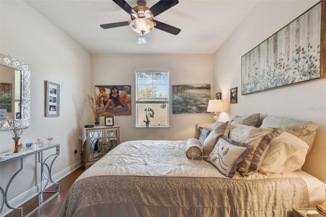 bedroom with a ceiling fan, baseboards, and wood finished floors