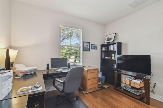 office space featuring visible vents and wood finished floors